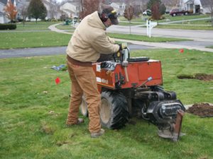 man on an irrigation installation machine